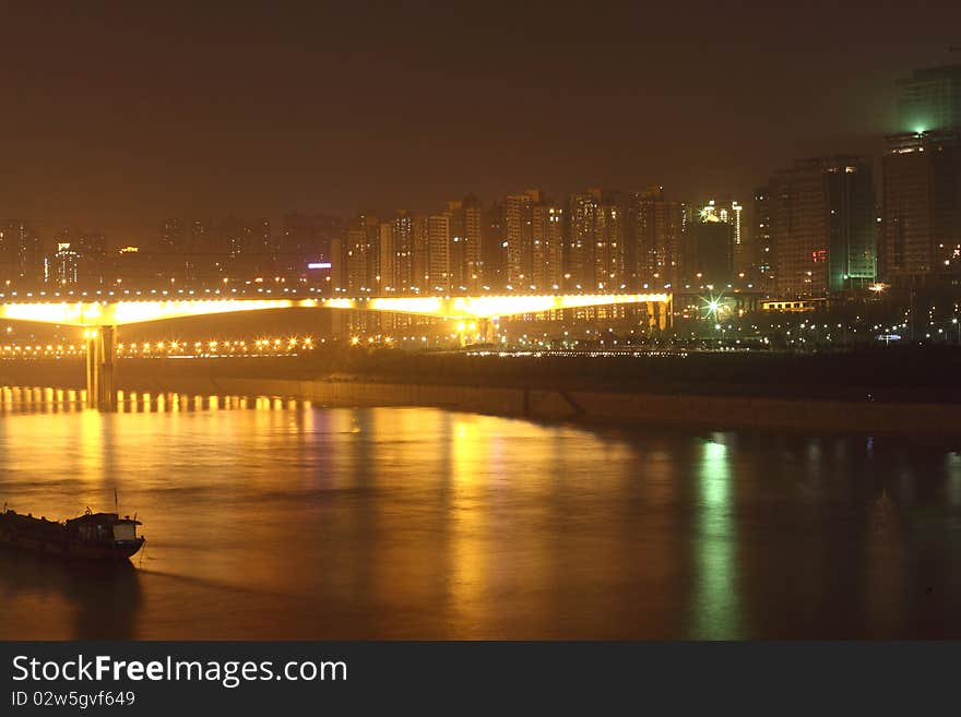 China mountain city - Chongqing, have a very beautiful night scene, bright river, bright building, shining Bridge. China mountain city - Chongqing, have a very beautiful night scene, bright river, bright building, shining Bridge