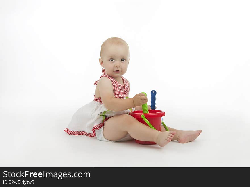 Baby with pail and shovel, on white background.