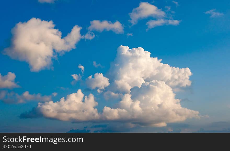 White fluffy cumulus clouds on a blue sky