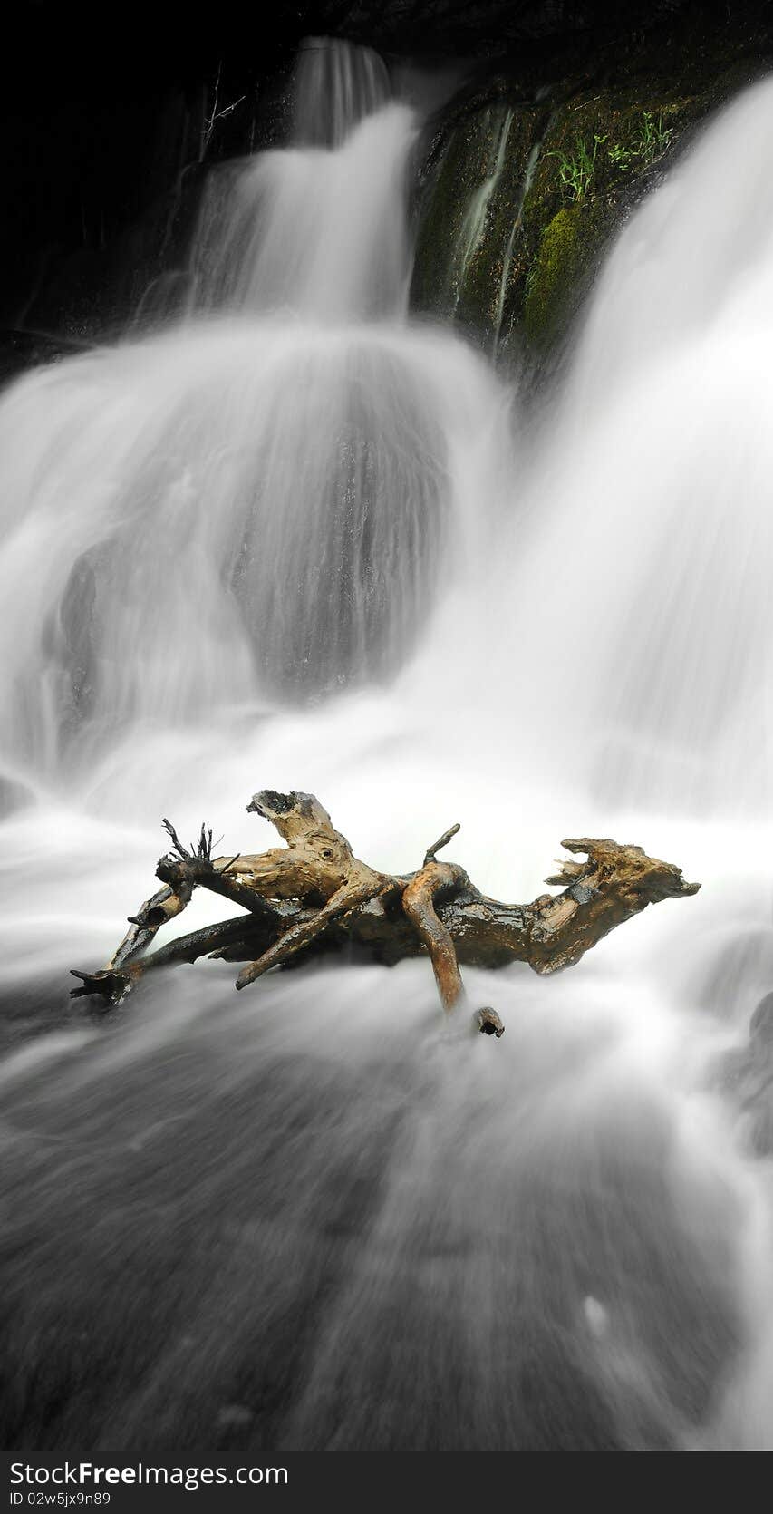 Long exposure of a waterfall with a wooden stick from a branch. Long exposure of a waterfall with a wooden stick from a branch.