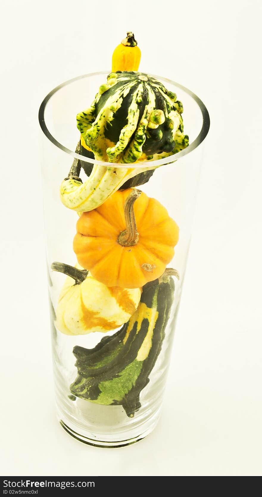 This is an image of a vase full of gourds.