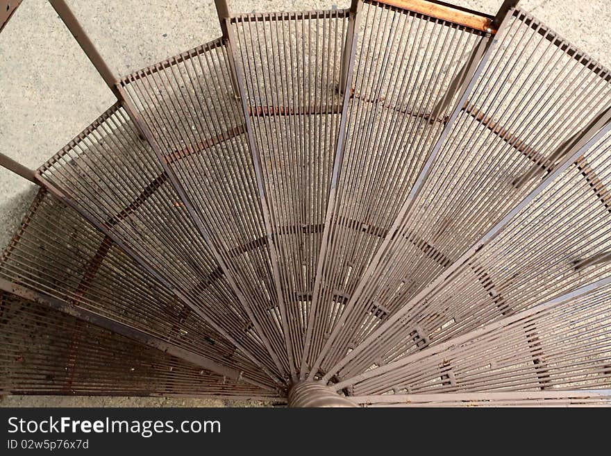 A spiral steel stair case texture descending. A spiral steel stair case texture descending