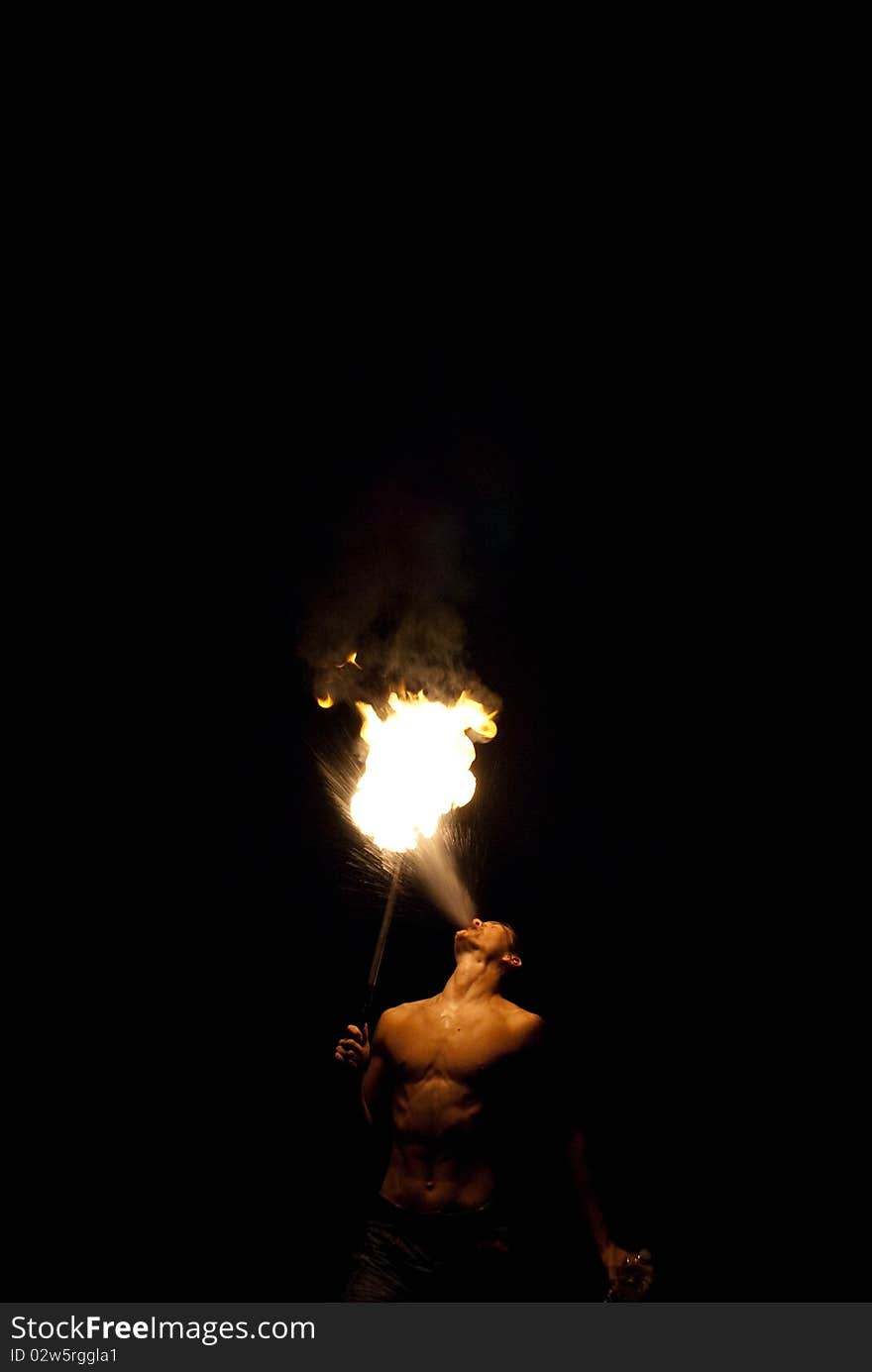 Fire-eater performance on a street