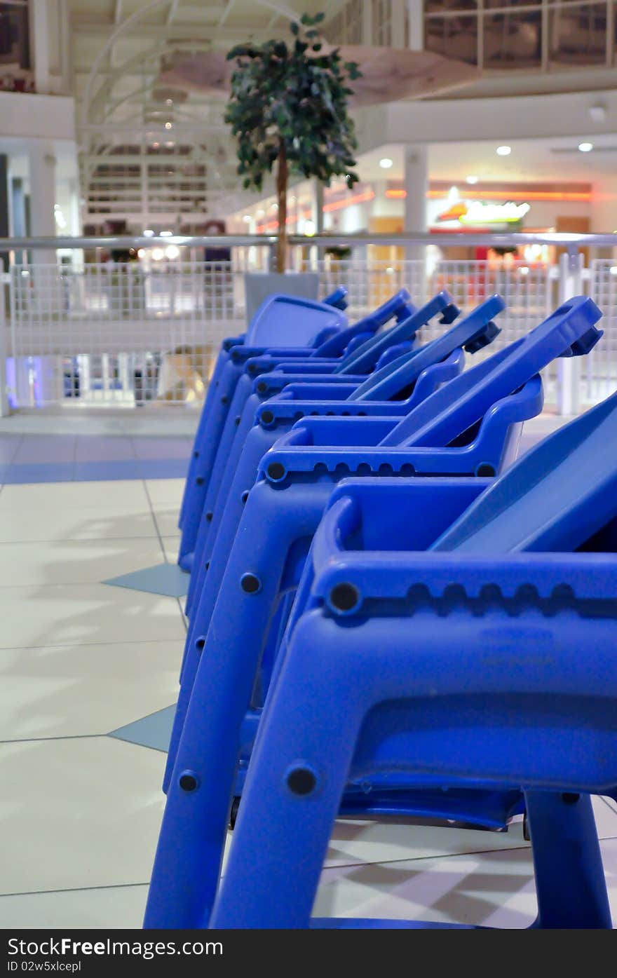 Baby chairs in line in shopping mall