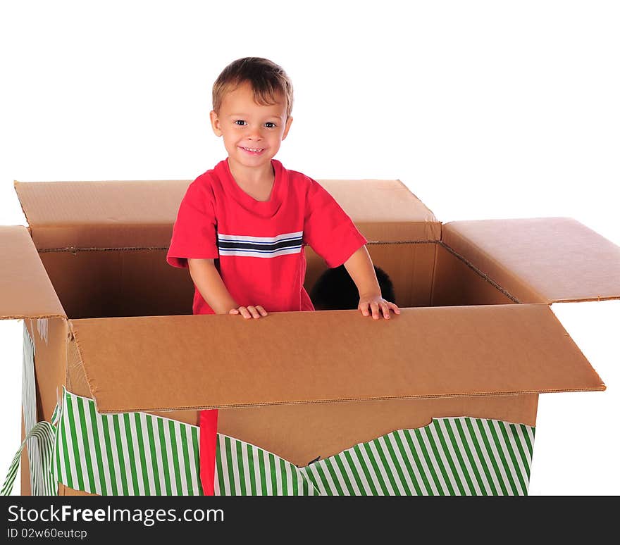 A happy preschooler playing in a giant-sized box with left-over Christmas wrappings.  His brother's head visible inside as well. A happy preschooler playing in a giant-sized box with left-over Christmas wrappings.  His brother's head visible inside as well.