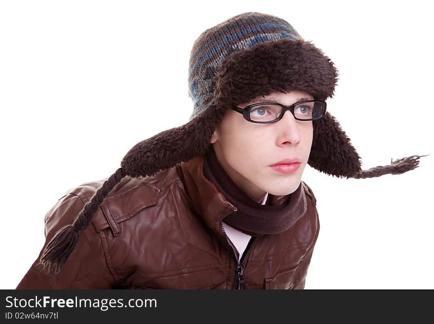 Young boy looking serious, with winter clothes and hat in the wind, isolated on white, studio shot