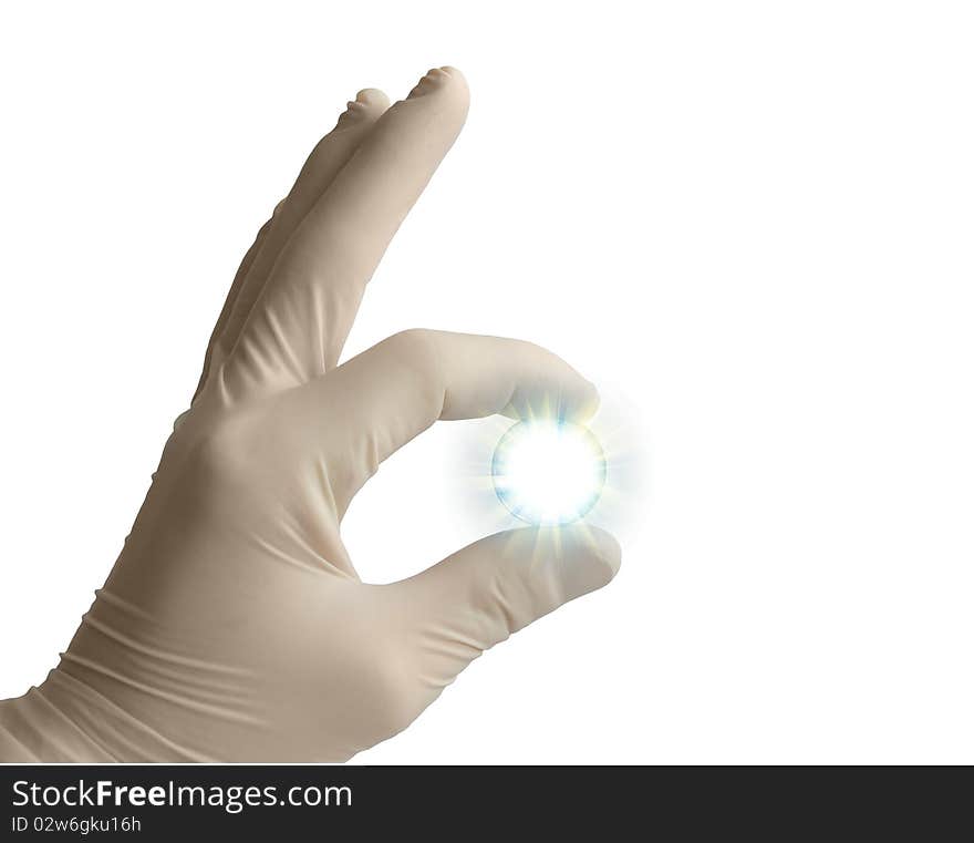 The hand in a medical glove holds a shining sphere