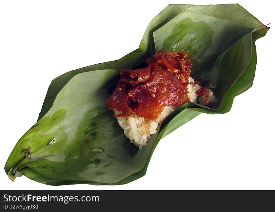 Sweet meat on sticky rice inside banana leaf package.