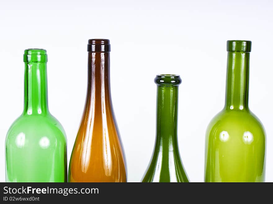 Four colored bottles on a white background.