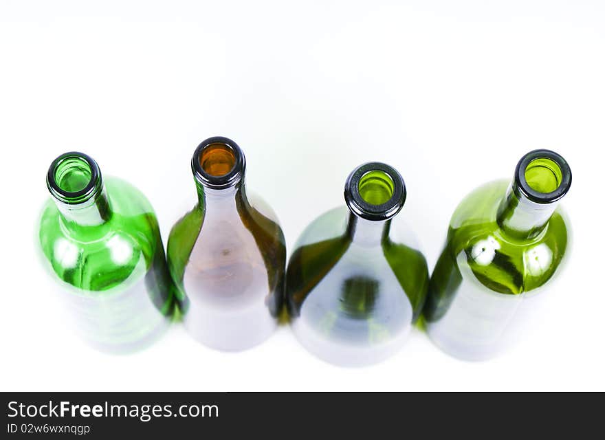 Four colored bottles on a white background