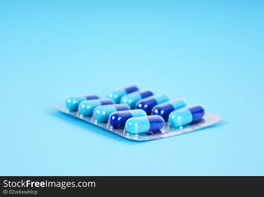 Medical tablets isolated on blue background