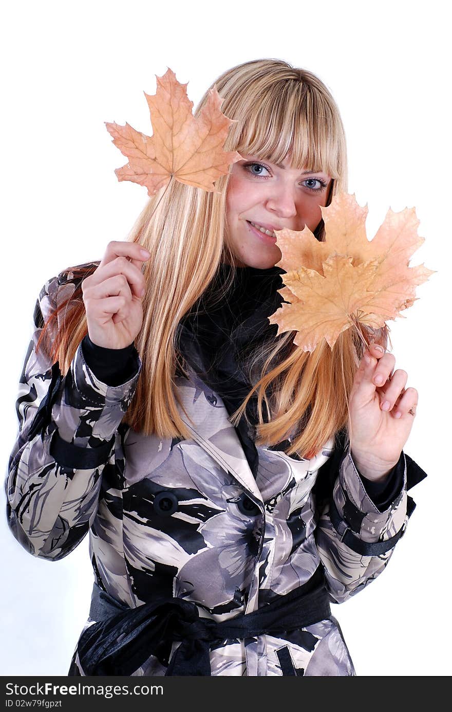 Cute blond with yellow autumn leaf in the hands. Cute blond with yellow autumn leaf in the hands