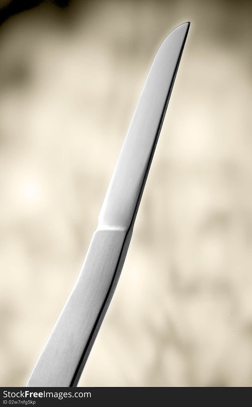 Designer knife in front of light background.