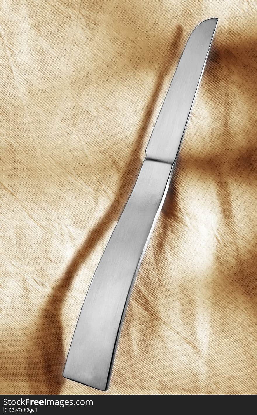 Designer knife in front of light background.