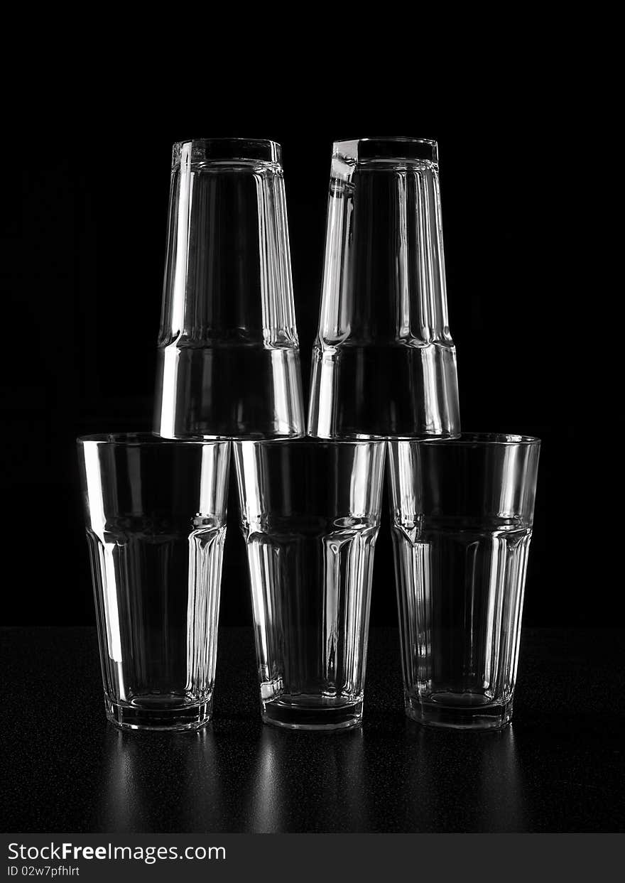 Structure like a piramid from five glasses in dark color. Structure like a piramid from five glasses in dark color