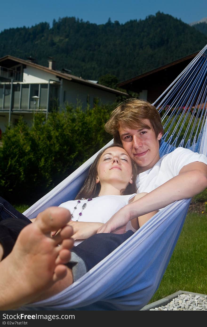 Young cute teenage couple in a hammock enjoying a sunny afternoon. Young cute teenage couple in a hammock enjoying a sunny afternoon.