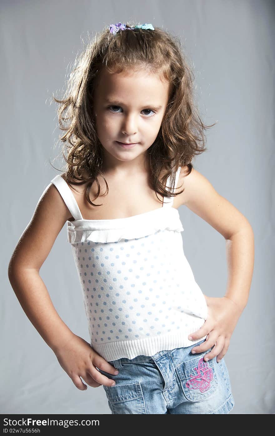 Young cute girl against grey background