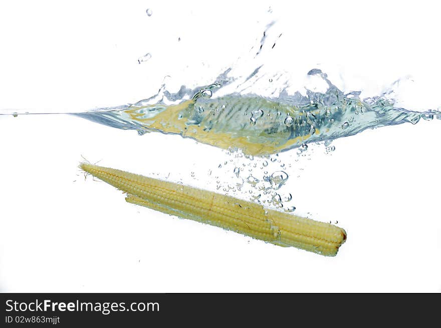 Fresh Babycorn drop to water in isolated. Fresh Babycorn drop to water in isolated