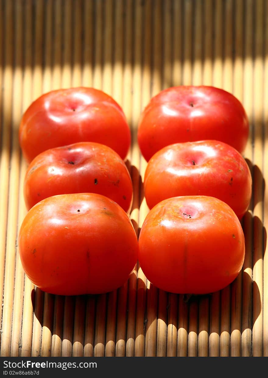 Ripe persimmons in autumn ,delicious fruit.