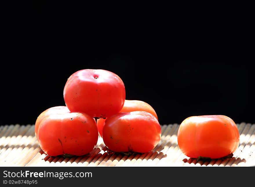 Delicious persimmon on the black backgrounds.