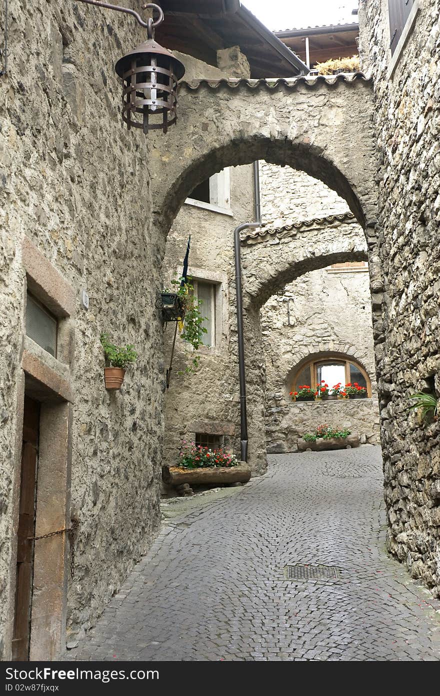 Passage of stone arcs in the medieval Italian village near Garda lake. Passage of stone arcs in the medieval Italian village near Garda lake