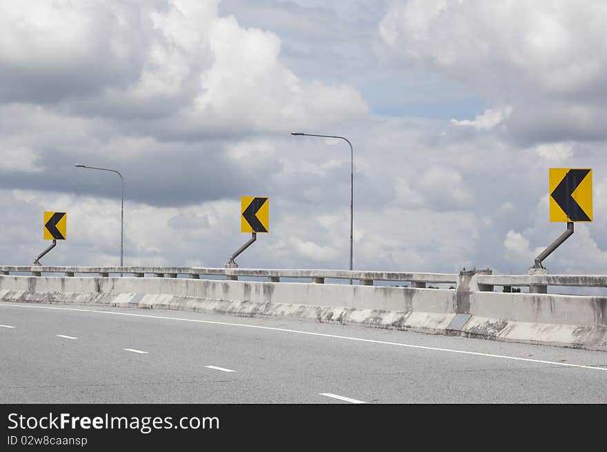 Sign turn on street to bridge. Sign turn on street to bridge