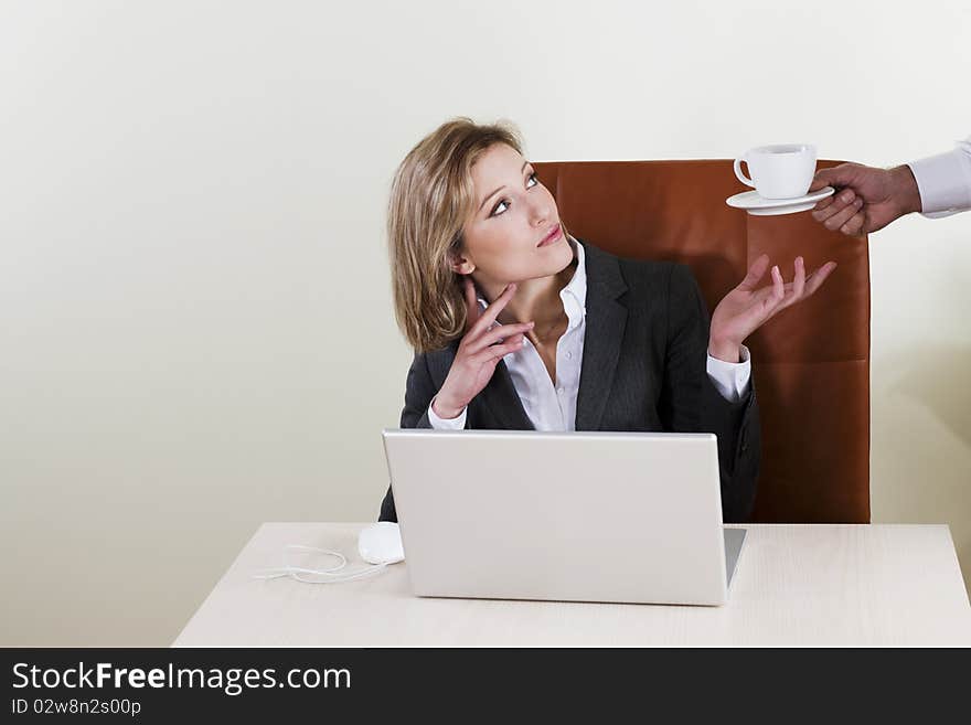 Female manager having coffee served by his male colleague