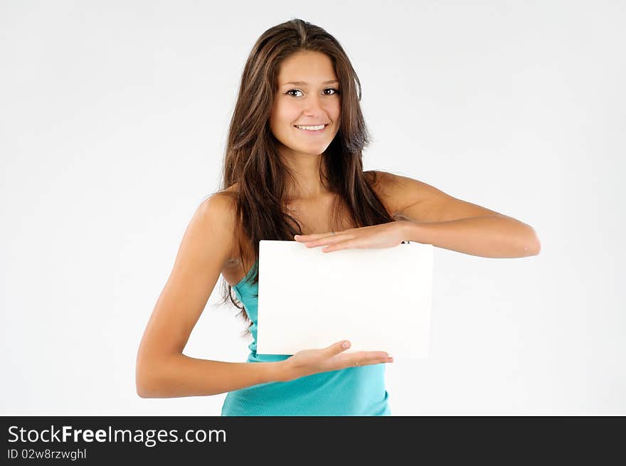 Young model holding empty signboard and looking at camera. Young model holding empty signboard and looking at camera