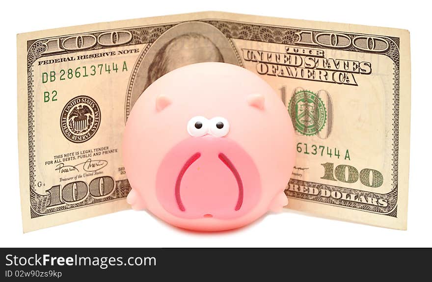 Toy pink pig and cash on a white background