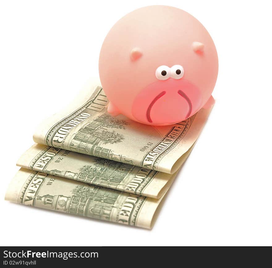 Toy pink pig and cash on a white background