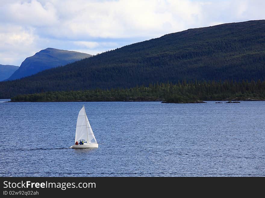 Sailboat in a lake at the mountains. Sailboat in a lake at the mountains