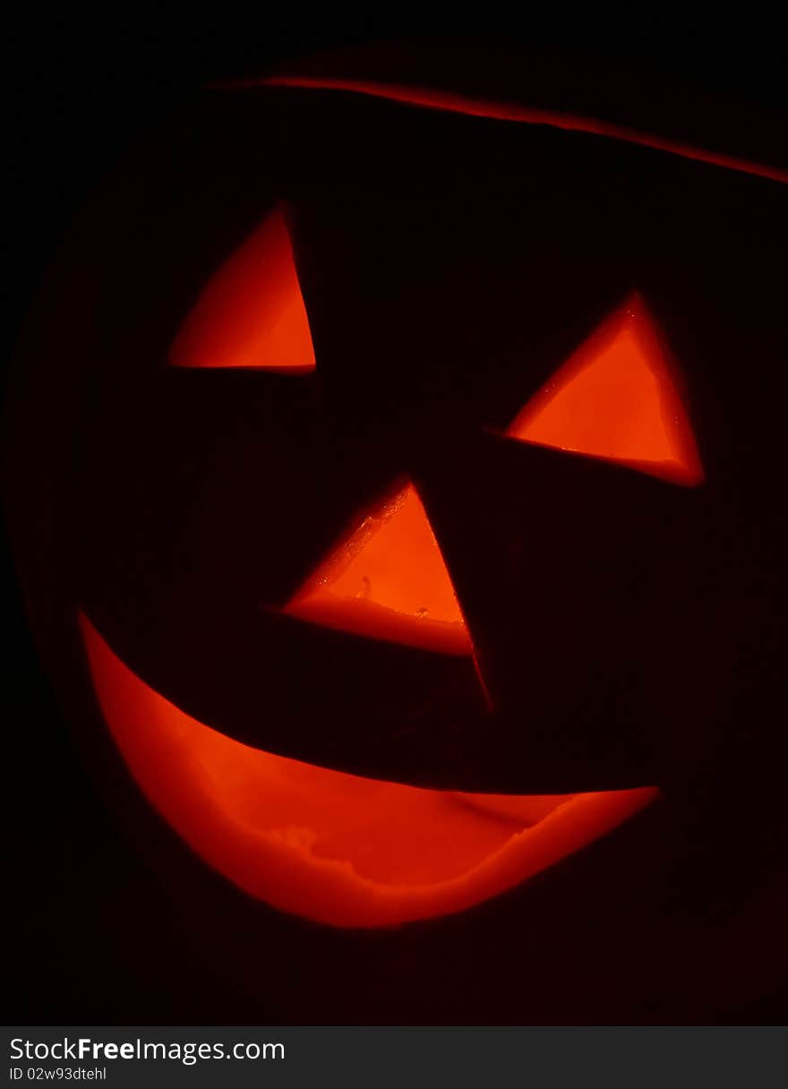 Jack-o-lantern glowing on black background