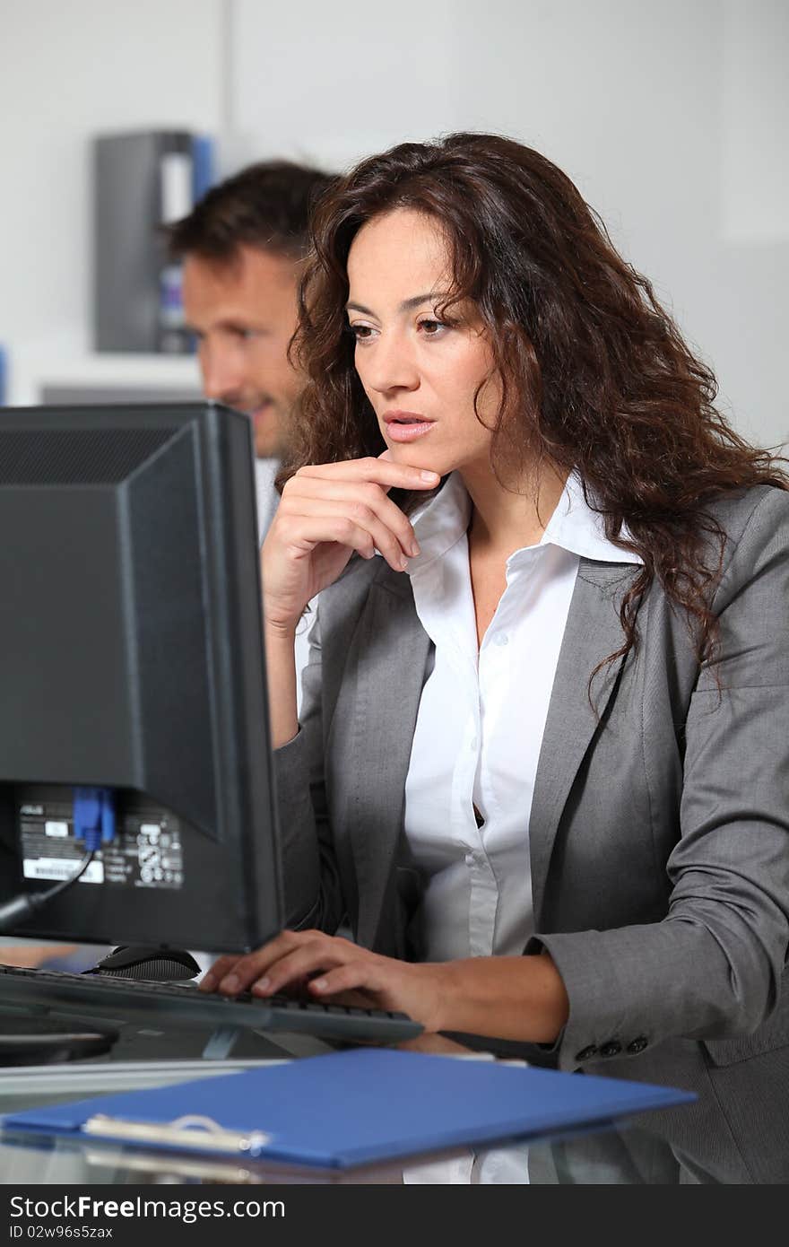 Beautiful woman typing on computer desk. Beautiful woman typing on computer desk