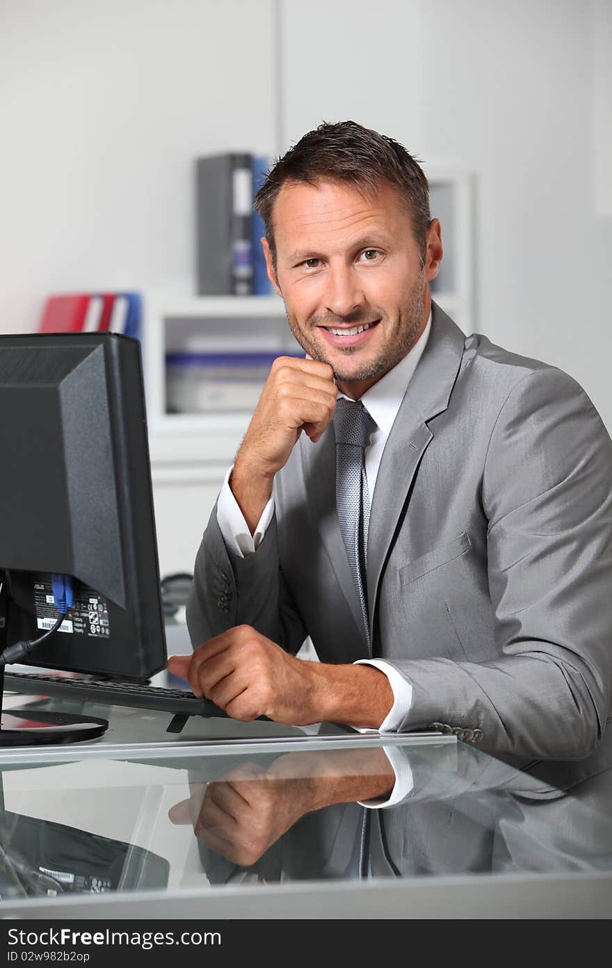 Closeup of businessman at his desk. Closeup of businessman at his desk