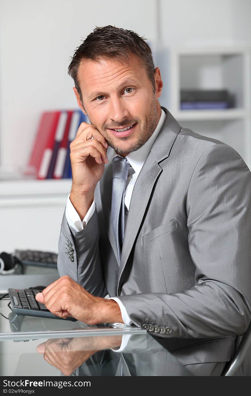 Closeup of businessman at his desk. Closeup of businessman at his desk