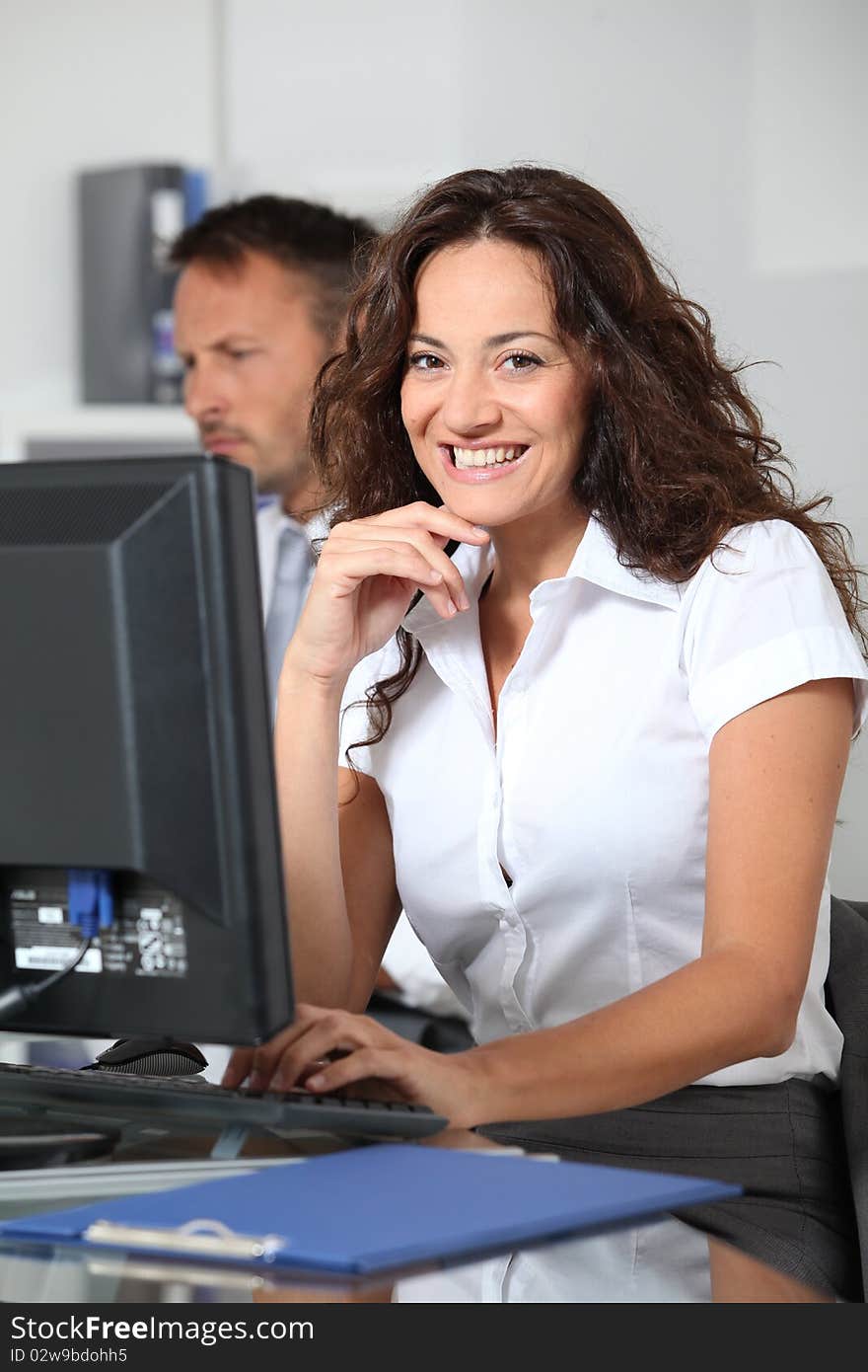 Beautiful woman typing on computer desk. Beautiful woman typing on computer desk