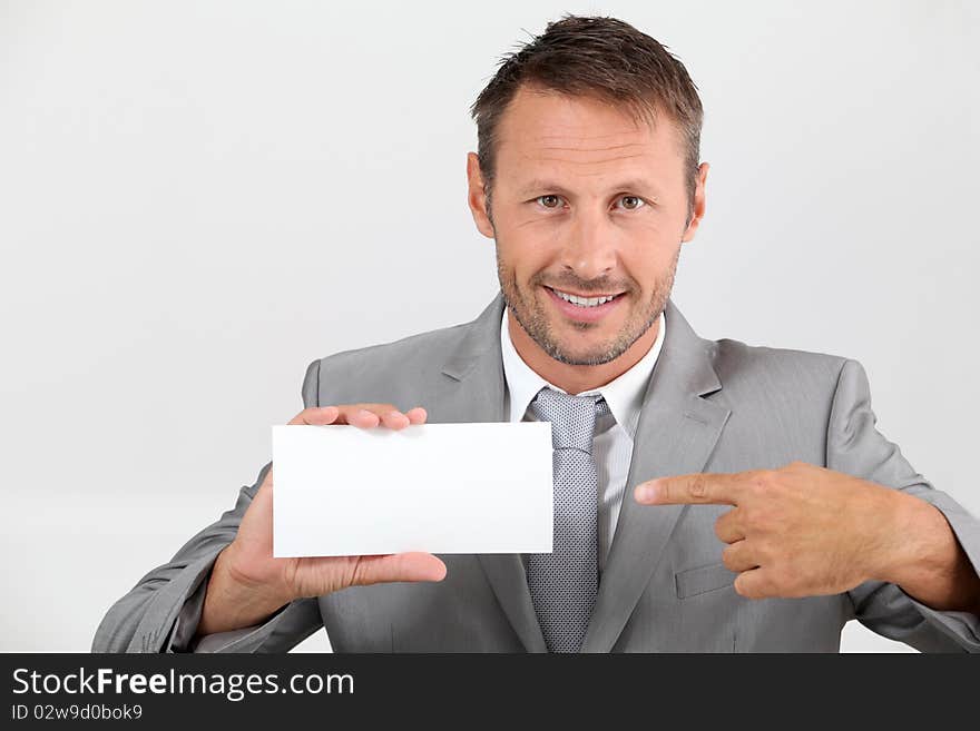 Businessman pointing at business card. Businessman pointing at business card