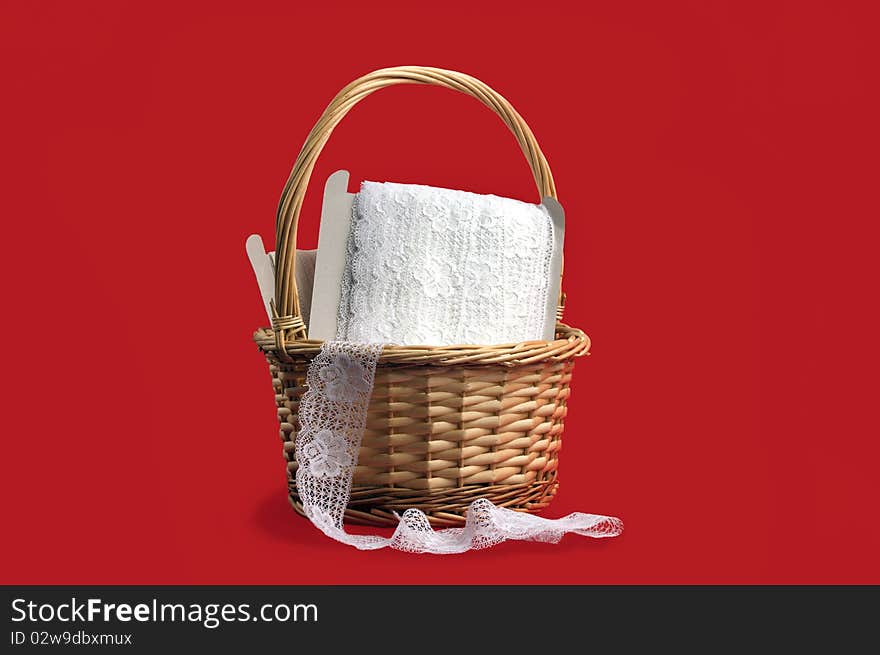 Basket with lace on red background