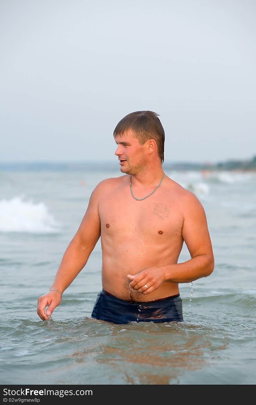 Young man standing in water