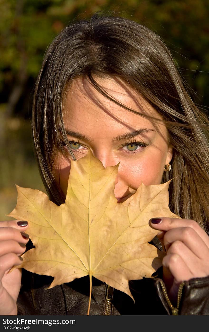 woman holding a maple leaf