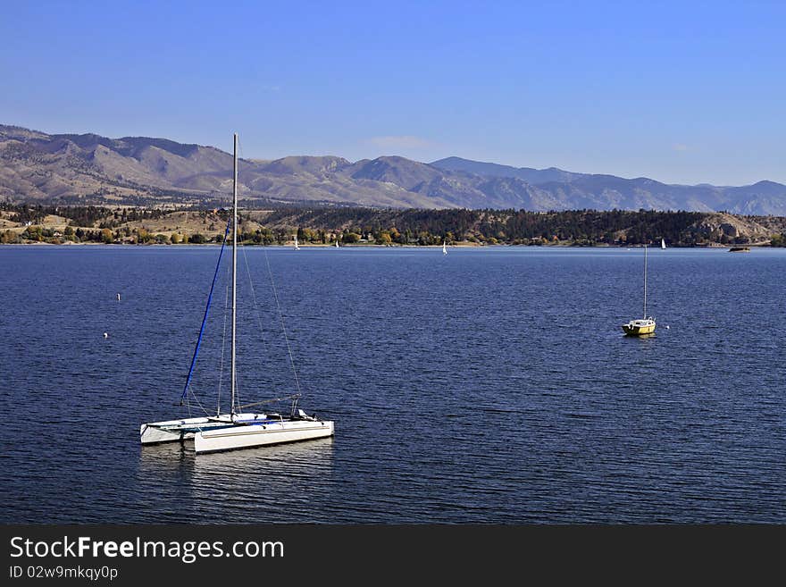 Two anchored sailboats in the middle of a lake on a summer's day in Montana