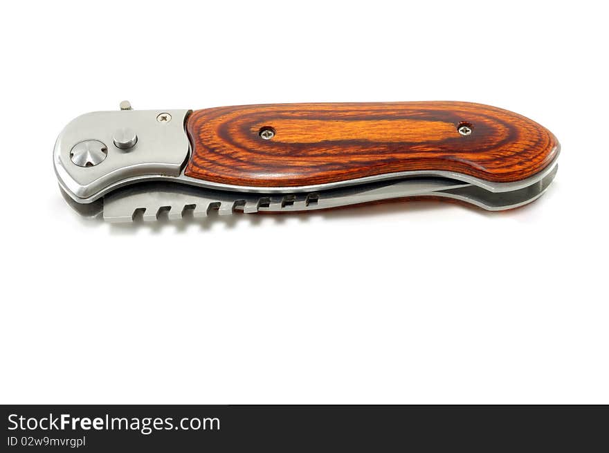 The collapsible closed knife is isolated on a white background. The collapsible closed knife is isolated on a white background