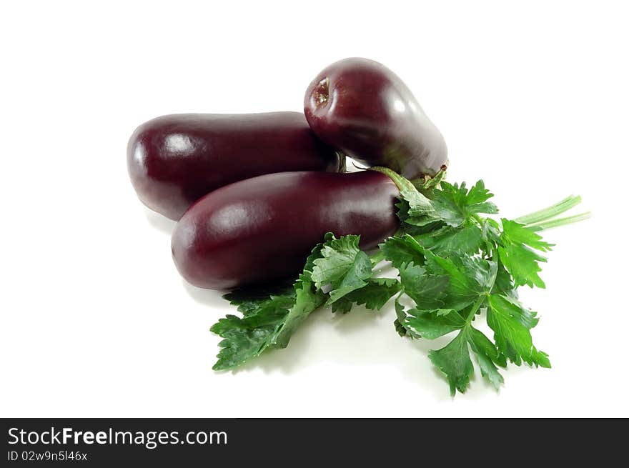 Ripe eggplants and celery greens are isolated on a white background