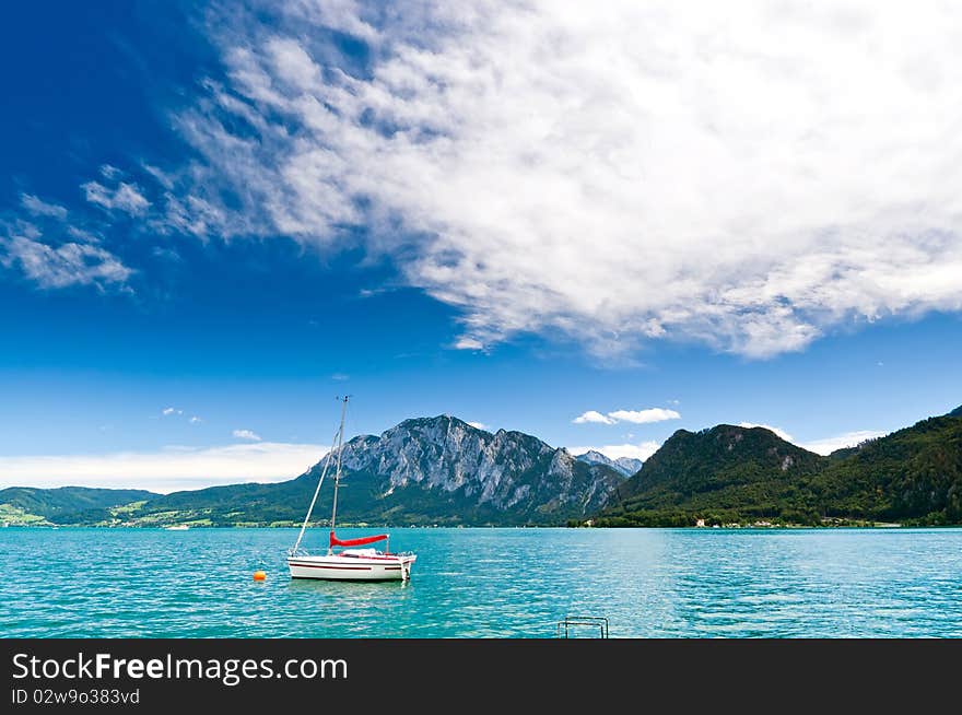 Yacht on a blue alpine lake. Salzkammergut. Austria. Yacht on a blue alpine lake. Salzkammergut. Austria