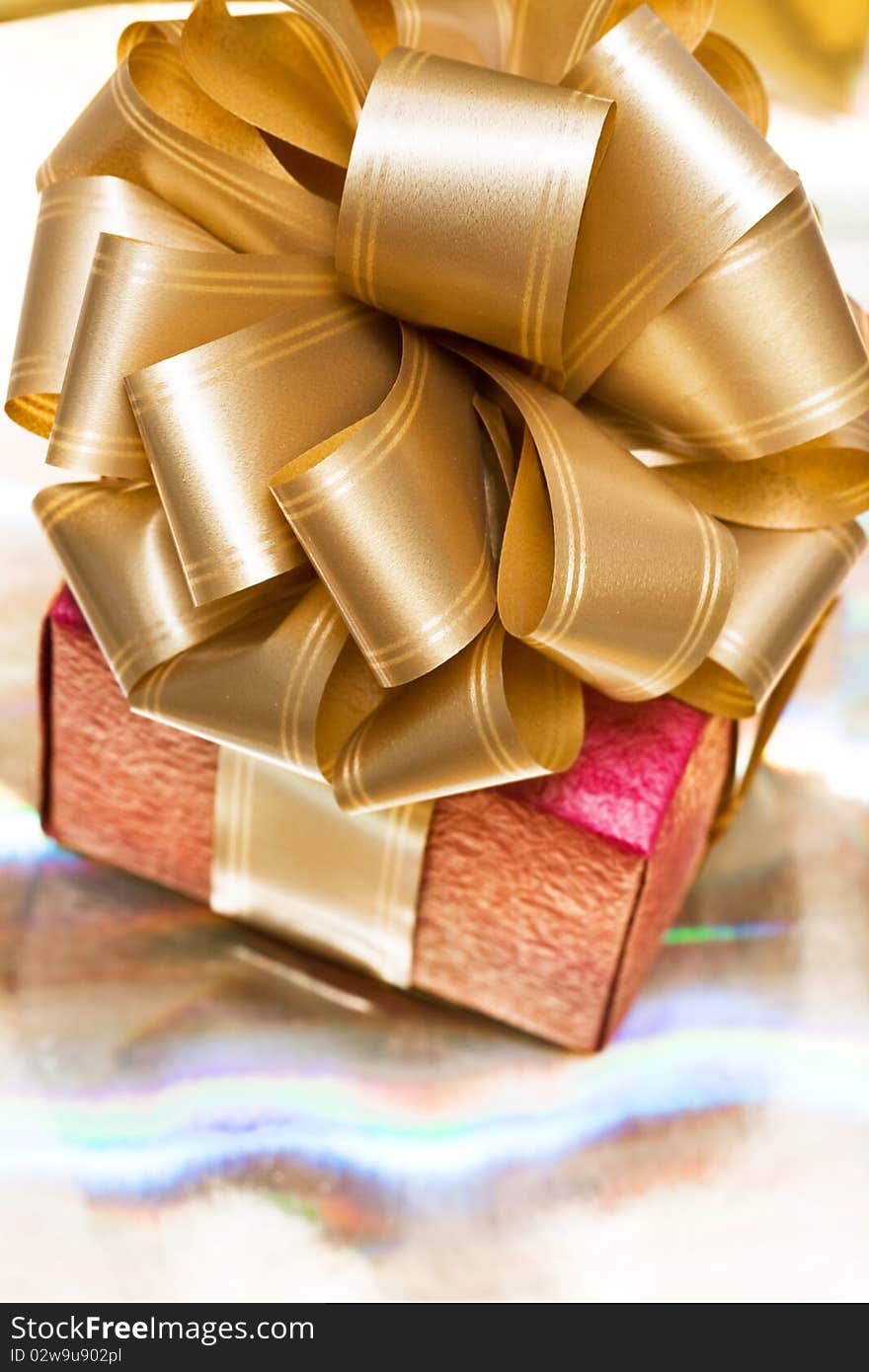 Red gift box on golden background