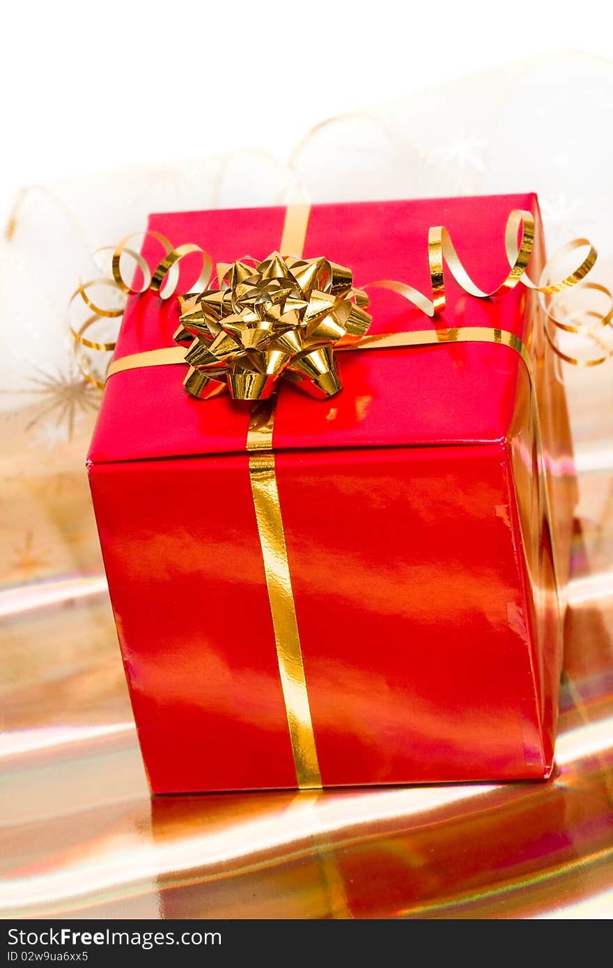 Red gift box on golden background