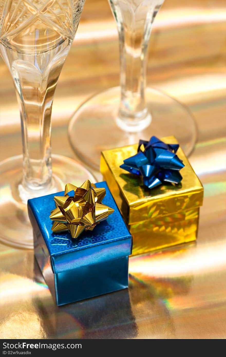 Gift boxes with glasses of champagne