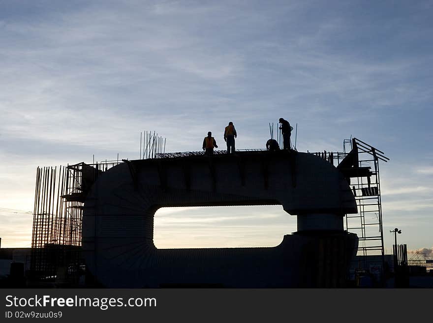 Silhouette of construction and workers at twilight. Silhouette of construction and workers at twilight