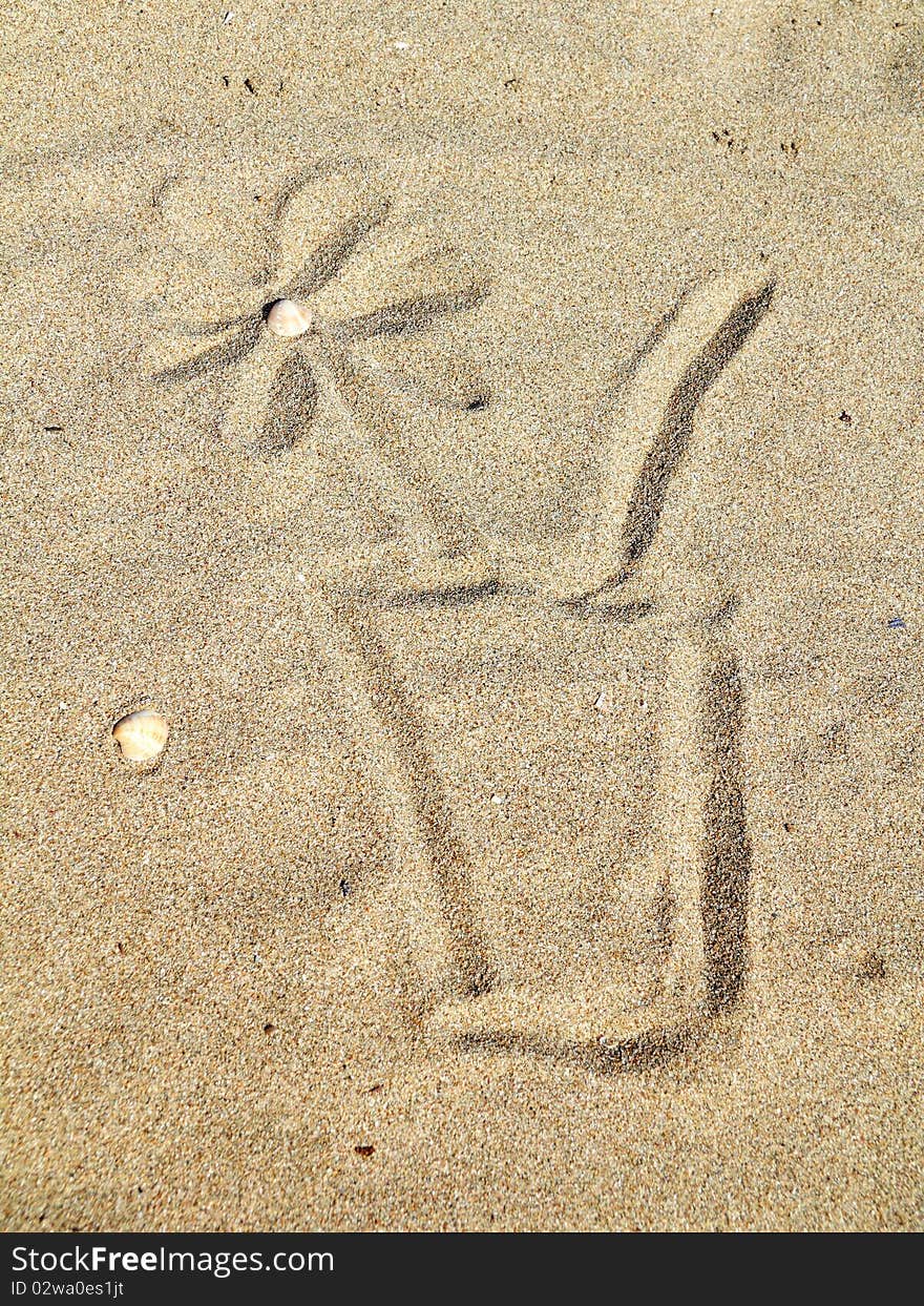 Drawing  a cocktail glass on sand. Drawing  a cocktail glass on sand