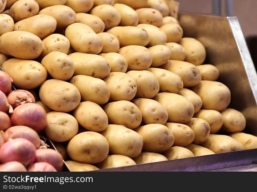 Fresh yellow baked potatoes at the market